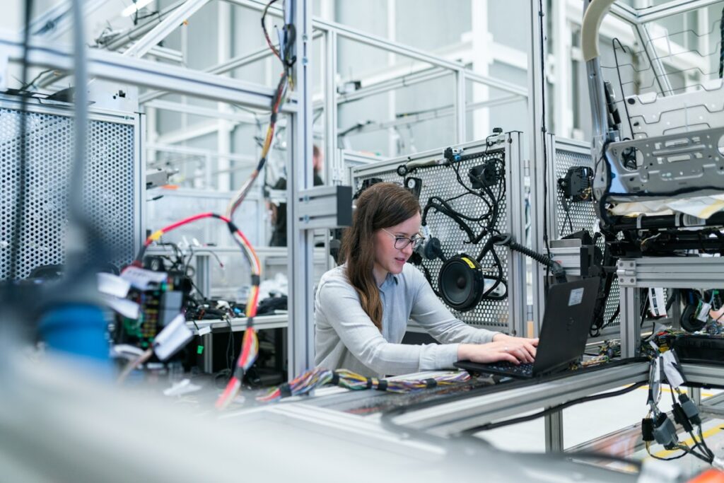 Industrial IoT solutions — engineer testing sensor integration on a factory automation rig